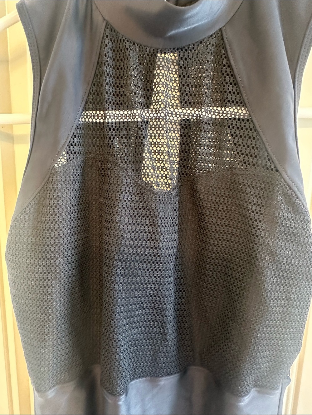 Black leotard with mesh netting.